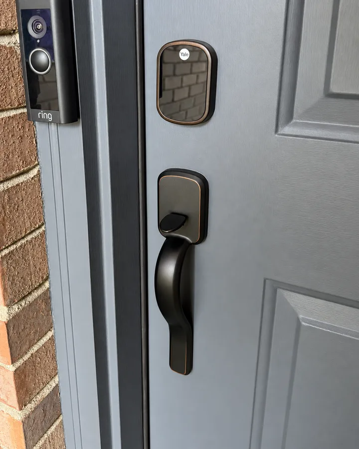 Yale keypad smart lock on a grey front door, before