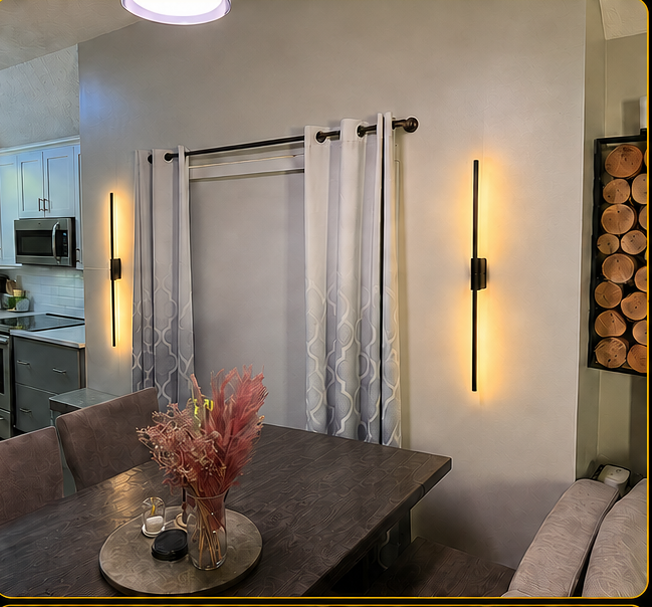 Dining room with two linear sconces and a pendant lit together